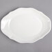 A white porcelain oval pickle dish with a curved edge.