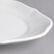 A close-up of a Villeroy & Boch white porcelain oval pickle dish with a curved edge.
