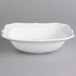 A white Villeroy & Boch porcelain square salad bowl with a wavy edge.