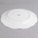 A white porcelain round platter with a small rim.