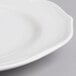 A close up of a Villeroy & Boch white porcelain round platter with a small rim.