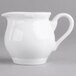 A white porcelain creamer with a white handle.