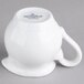A white porcelain creamer with a handle.