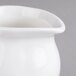 A close-up of a Villeroy & Boch white porcelain creamer with a small handle.