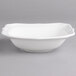 A white Villeroy & Boch porcelain bowl with a scalloped edge.