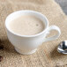 A white Villeroy & Boch porcelain cup of coffee with a spoon.