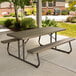 A brown Lifetime plastic rectangular picnic table with attached benches on a patio.