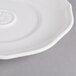 A close-up of a Villeroy & Boch white porcelain saucer with a circular design.
