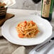 A plate of spaghetti with shrimp and wine on a Villeroy & Boch La Scala porcelain plate.