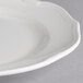 A close up of a Villeroy & Boch white porcelain flat plate with a small rim.