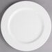 A white Villeroy & Boch porcelain flat plate with a white rim on a gray surface.