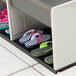 A Lifetime outdoor double locker with shoe storage holding a group of shoes.