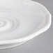 A white Villeroy & Boch porcelain saucer with a spiral design.