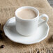 A white Villeroy & Boch La Scala saucer holding a white cup of coffee with brown foam.