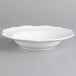 A white porcelain bowl with a scalloped edge.