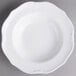 A Villeroy & Boch white porcelain soup plate with a scalloped edge.
