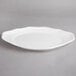 A white Villeroy & Boch porcelain oval plate with a scalloped edge.