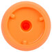 An orange plastic lid with a hole in the center.