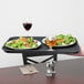 A Carlisle non-skid fiberglass serving tray with a salad, mushrooms, and carrots on it.