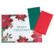 A white rectangular placemat with a red border and poinsettia design.