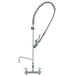 A T&S stainless steel deck mounted pre-rinse faucet with a hose.