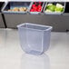 A San Jamar plastic container with a lid and a tray on a white surface.