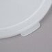 A white plastic lid with a small hole for a Cambro round food storage container.