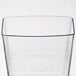 A clear plastic tumbler with a thin wavy line.