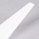 A close-up of a Fineline white plastic spoon.
