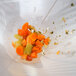 A white Matfer Bourgeat Exoglass bouillon strainer filled with chopped carrots and celery.