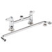 A chrome Equip by T&S deck-mount faucet with two handles and a swing nozzle.
