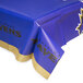 A blue table cover with black and gold Baltimore Ravens text.