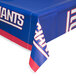A New York Giants plastic table cover on a table.