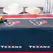 A table with a Houston Texans table cover, plates, and cups.