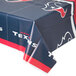 A Houston Texans plastic table cover with a logo on a table.