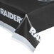 A black and white Creative Converting Las Vegas Raiders table cover on a table.