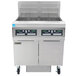 A large commercial Frymaster gas fryer with two stainless steel baskets.