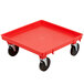 A red plastic Vollrath Traex dolly base with black wheels.