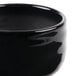 A close-up of a black Reserve by Libbey Pebblebrook porcelain bouillon bowl.