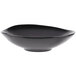 A close-up of a black Reserve by Libbey Pebblebrook bowl with a curved edge.