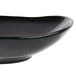 A black Reserve by Libbey Pebblebrook porcelain bowl with a curved edge.