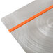 A Menu Solutions Alumitique aluminum menu board with orange bands on a metal surface.
