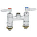 The silver T&amp;S deck mount faucet base with two Cerama cartridges and red and blue buttons.