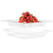 A clear acrylic ice tub filled with strawberries.