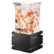 A Rosseto clear acrylic beverage dispenser with a black gloss base filled with water and orange slices.