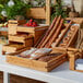 A table with different types of bread in a Rosseto Natura large bamboo tray.