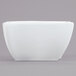 An American Metalcraft Prestige square wave porcelain bowl on a gray background.