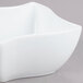 An American Metalcraft Prestige wave porcelain bowl on a gray surface.
