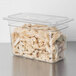 A Carlisle clear plastic food pan filled with chopped chicken.