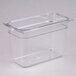 A Carlisle clear plastic food pan with a lid on a counter.